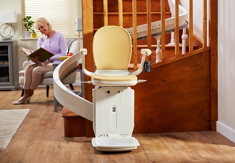 curved stairlift with couple in the background 