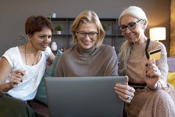 3 ladies looking at a stairlift photo