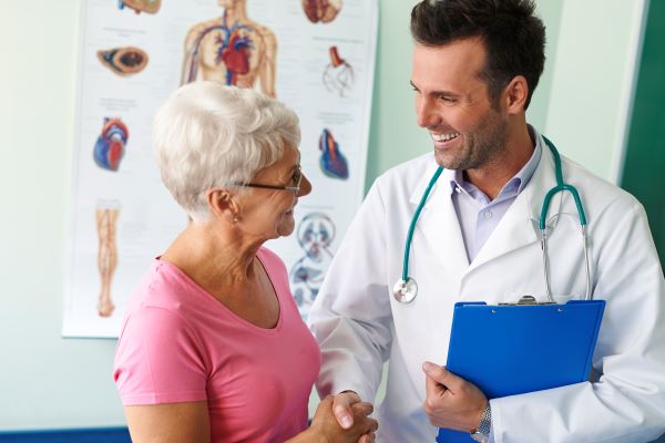 Senior woman talking to a smiling doctor