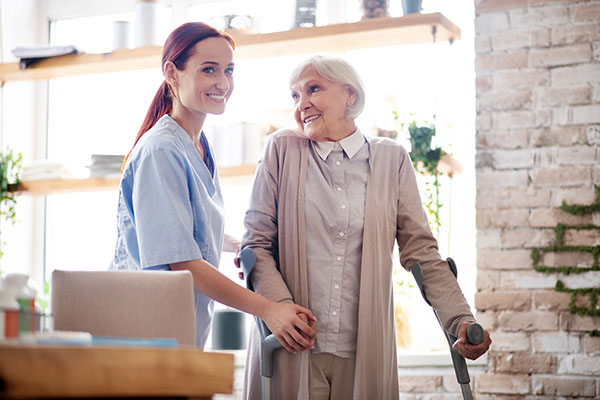 nurse helping patient with parkinson's disease walk