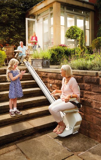 Woman enjoying the outdoors on her outdoor stairlift from acorn